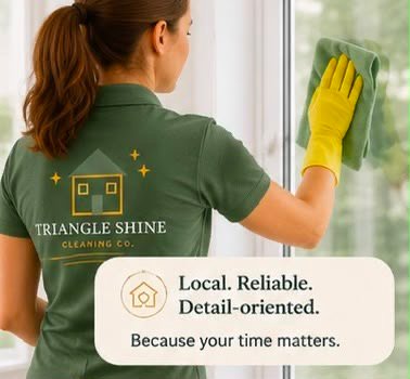 Triangle Shine cleaning professional wiping a window.
